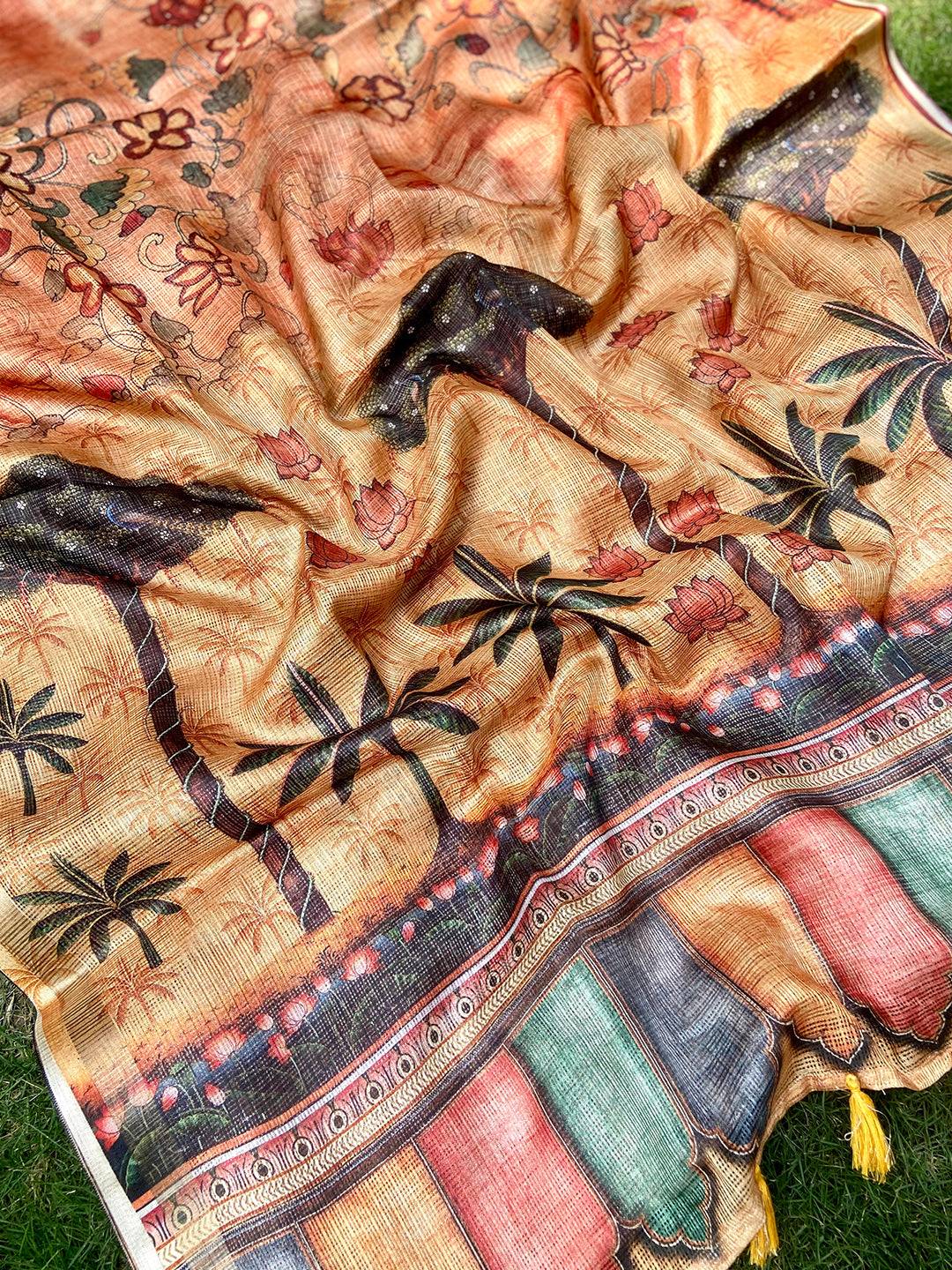 Detailed view of orange Kota Doriya silk saree with floral design.