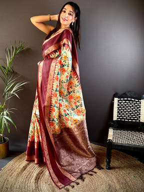 Model wearing maroon Banarasi saree with floral and Zari accents