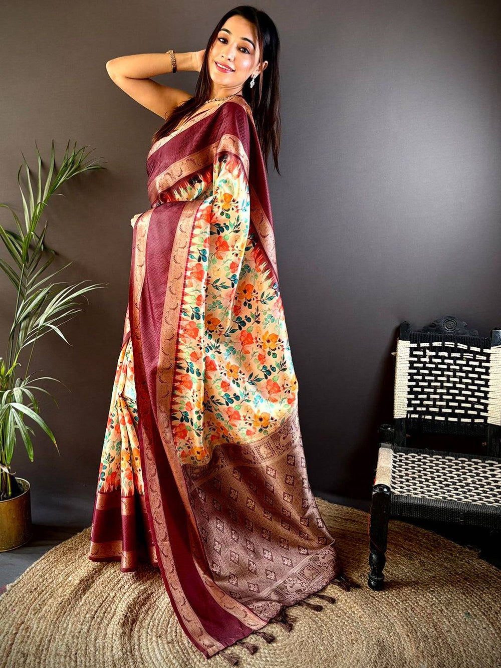 Model wearing maroon Banarasi saree with floral and Zari accents
