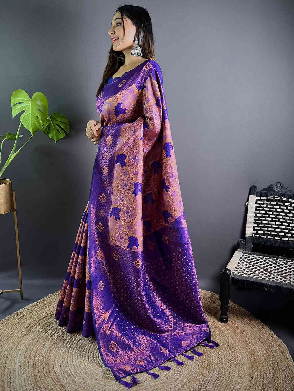 Side pose showcasing violet soft silk butta weaving saree.