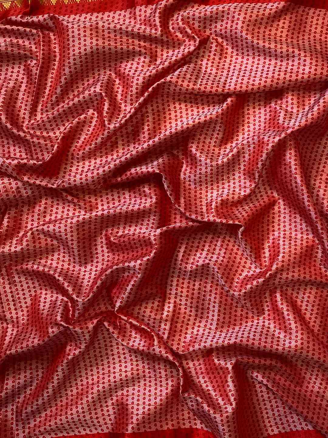 Close-up of red Bandhej print on soft silk fabric