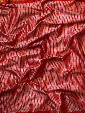 Close-up of red Bandhej print on soft silk fabric