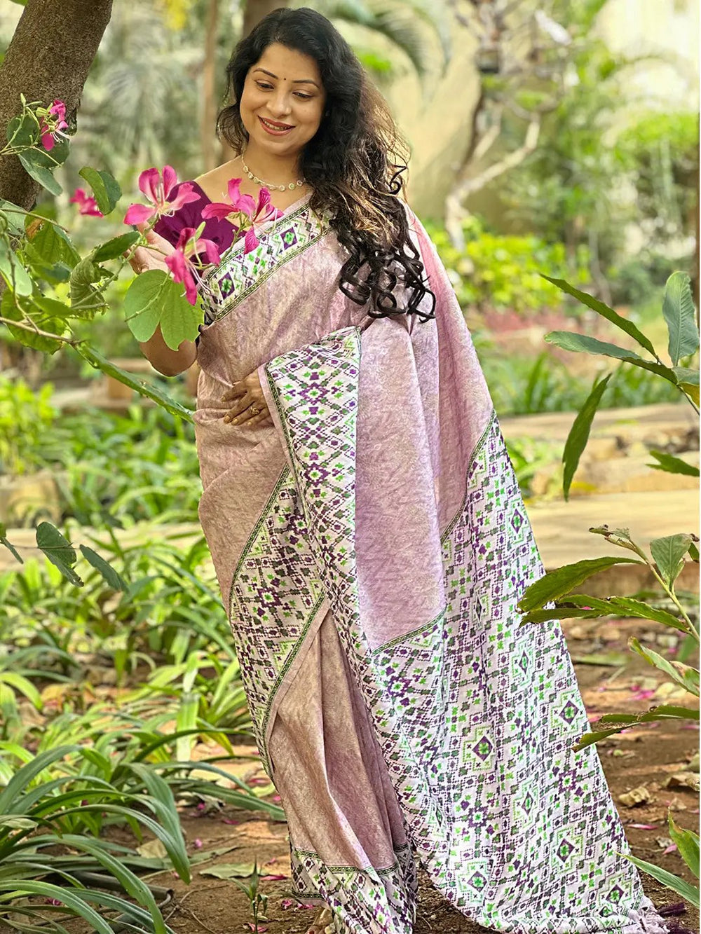 Elegant pink Kanjivaram saree with Patola print in garden
