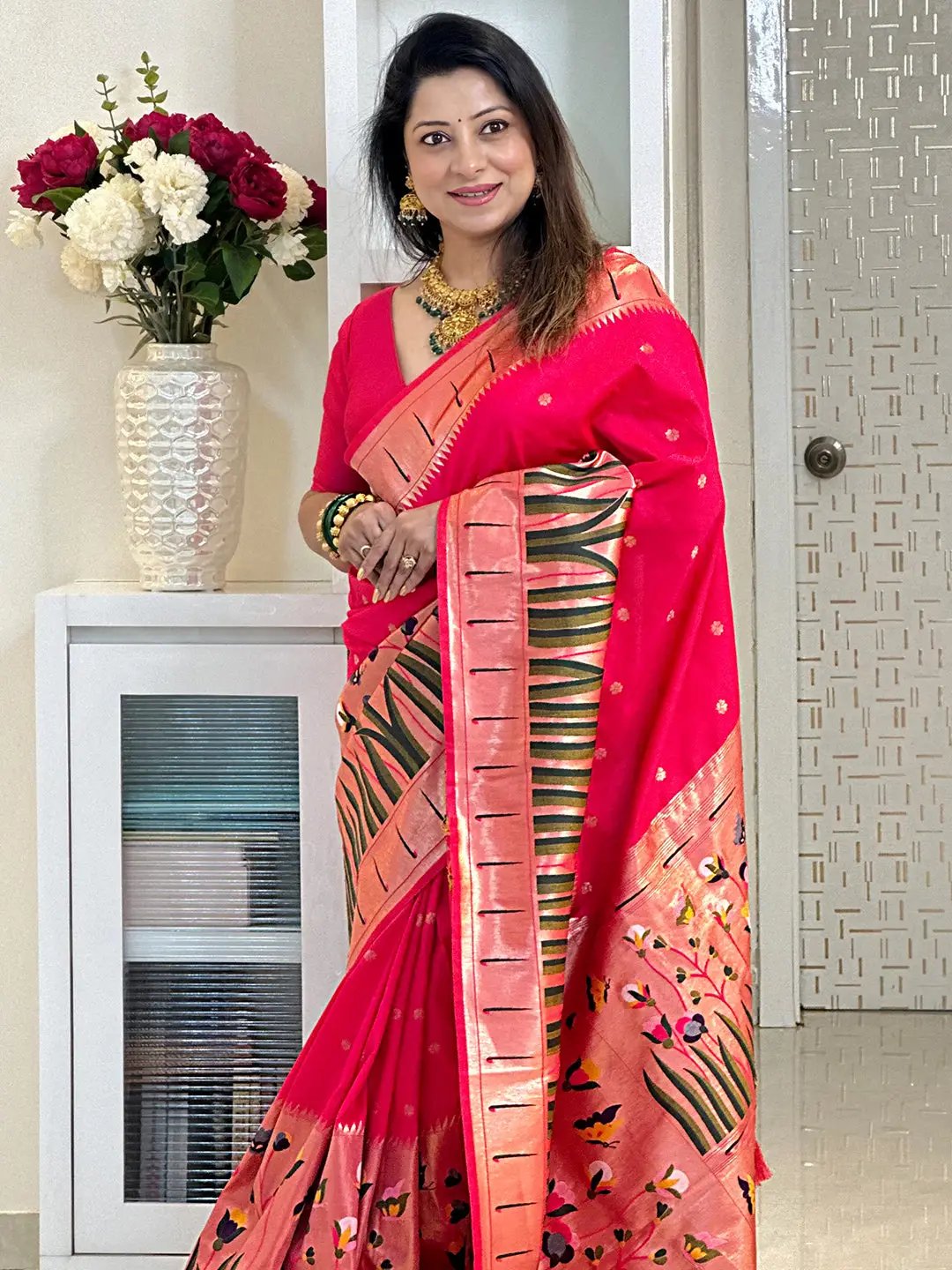 Traditional pink Paithani saree with intricate patterns