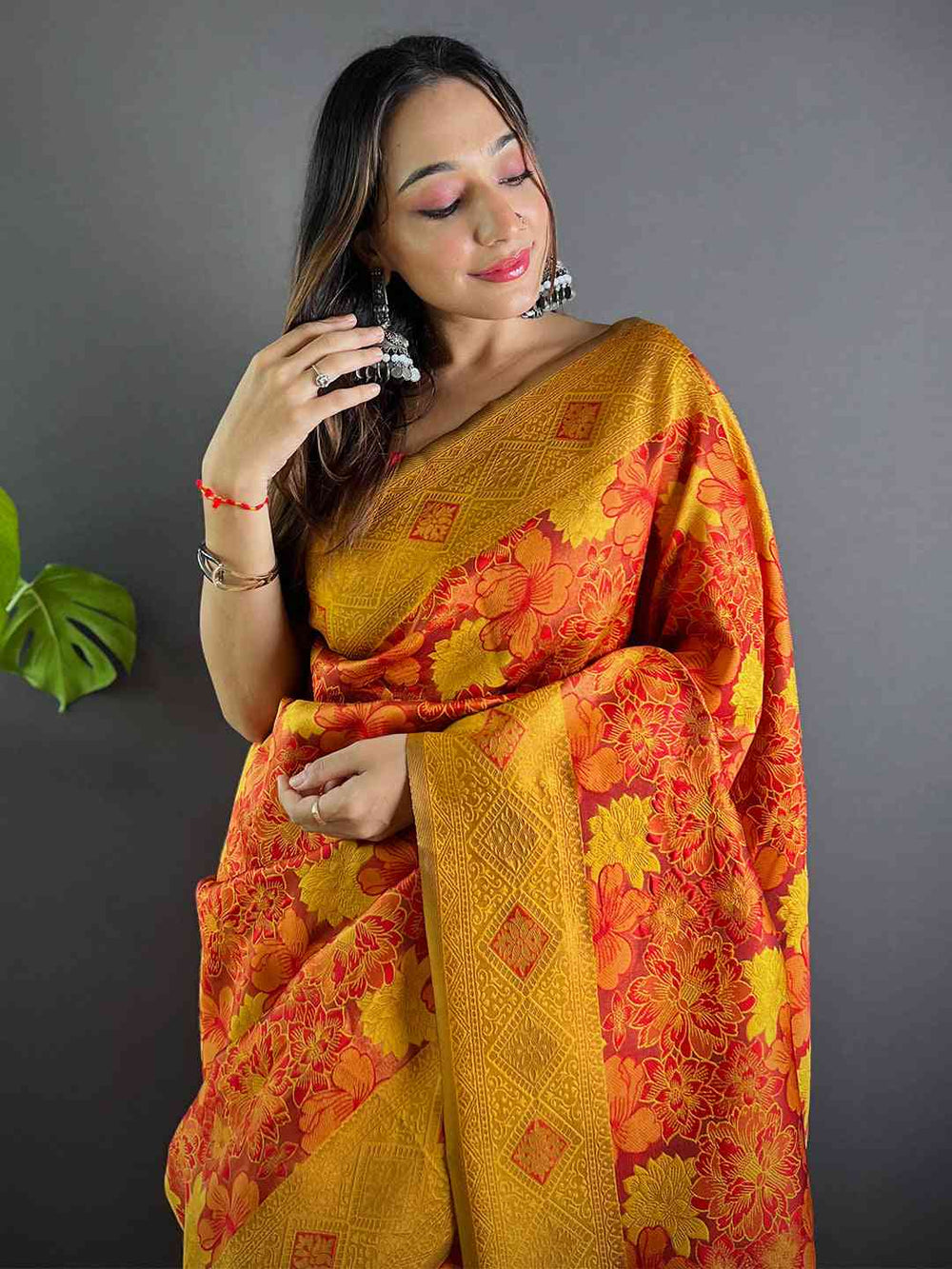 Rust soft silk saree with floral butta weaving, worn by model