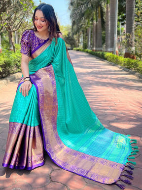 Turquoise Kanjivaram saree draped elegantly with purple blouse