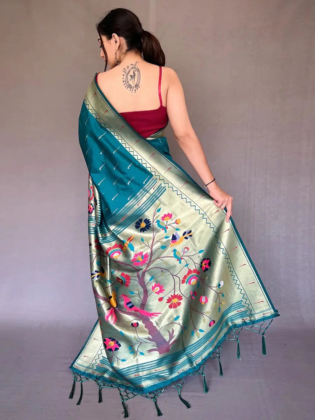 Back view of teal Paithani saree showcasing zari design.