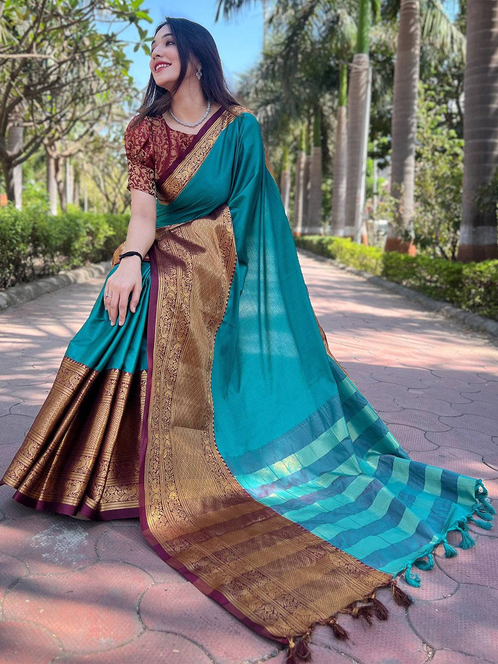 Teal Kanjivaram saree with luxurious gold detailing