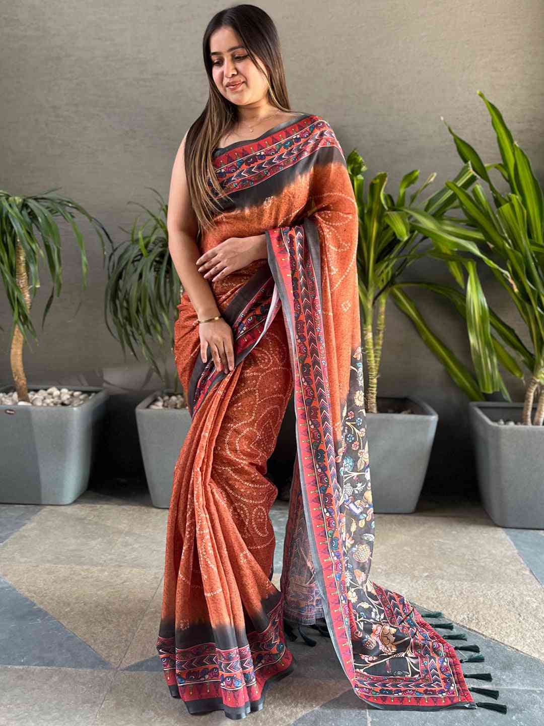 Orange saree with intricate Bandhej and Kalamkari designs, full view