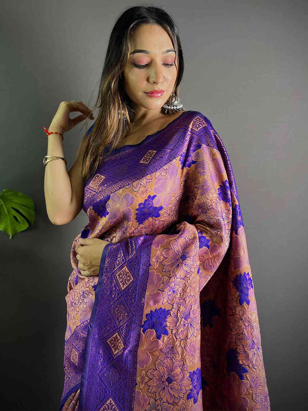 Violet soft silk butta weaving saree draped elegantly.