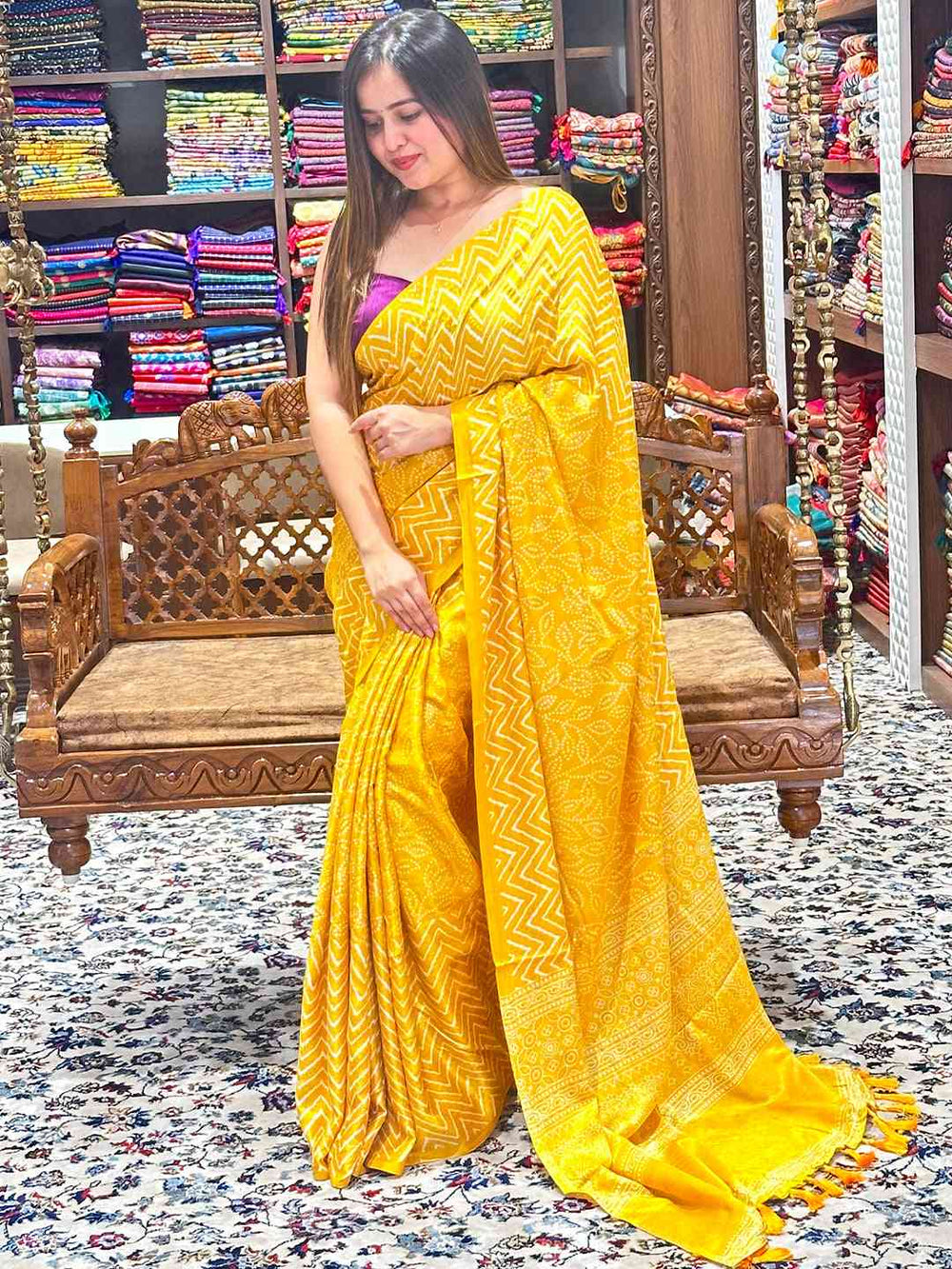 Vibrant yellow Manipuri silk saree with detailed foil print pattern.