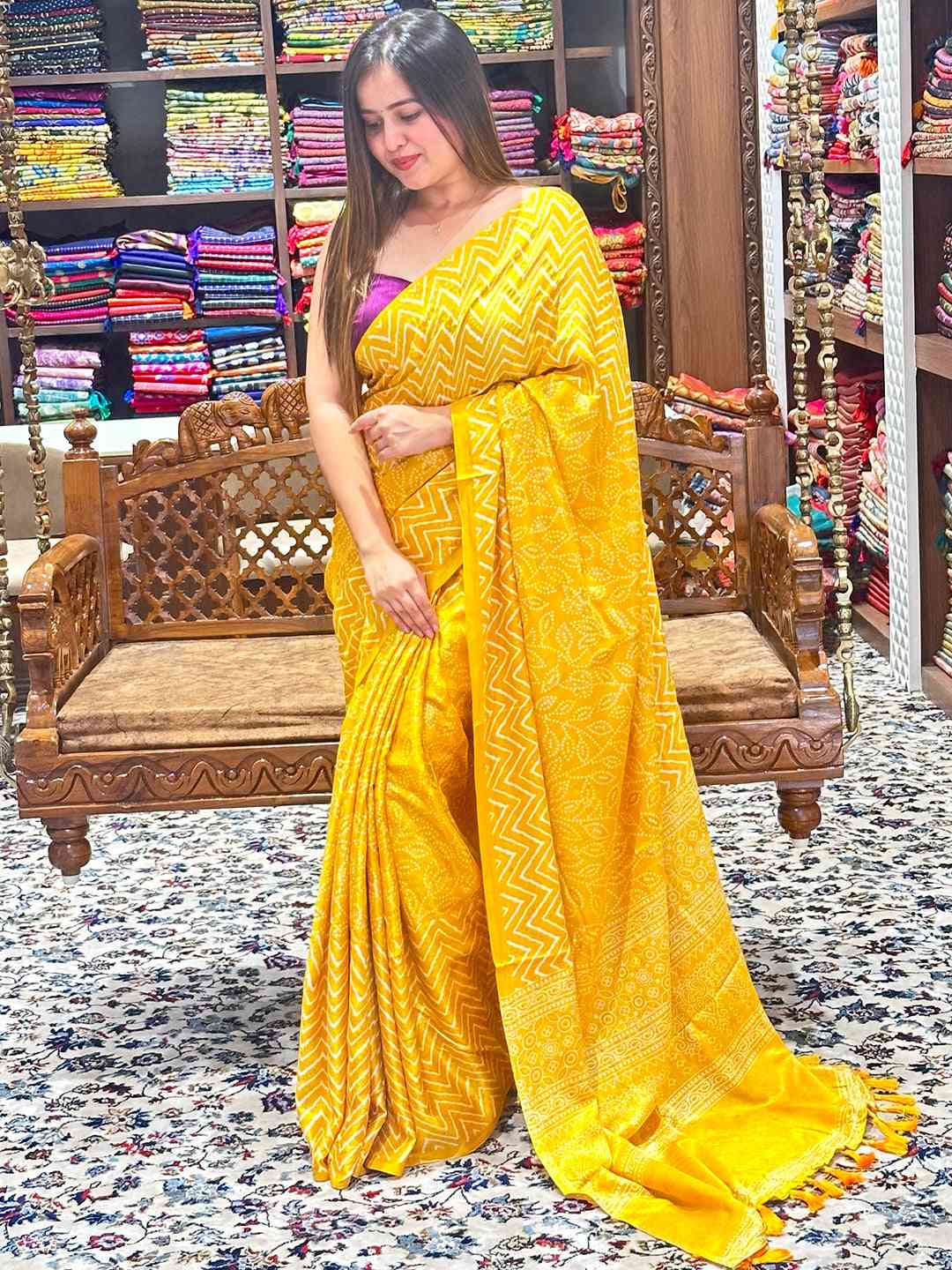 Vibrant yellow Manipuri silk saree with detailed foil print pattern.