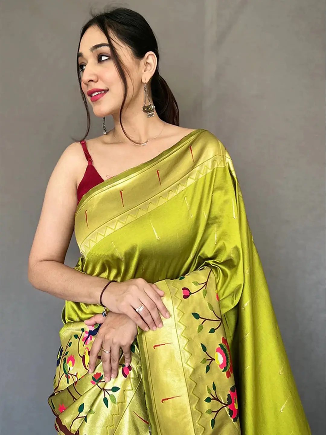 Close-up of light green Paithani saree with zari border