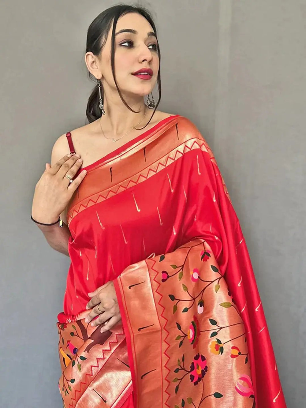 Close-up of Royal Red Paithani saree with detailed zari border.