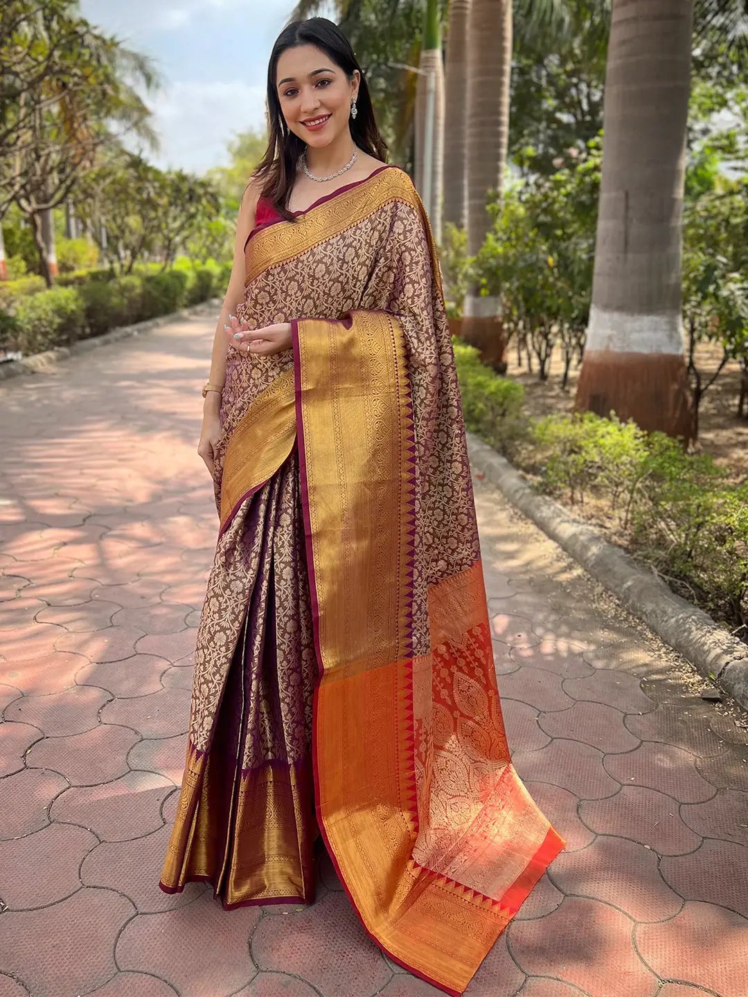 Brown one gram gold tissue saree with jacquard work, outdoor setting