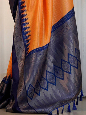 Detailed view of orange saree with blue zari weaving.