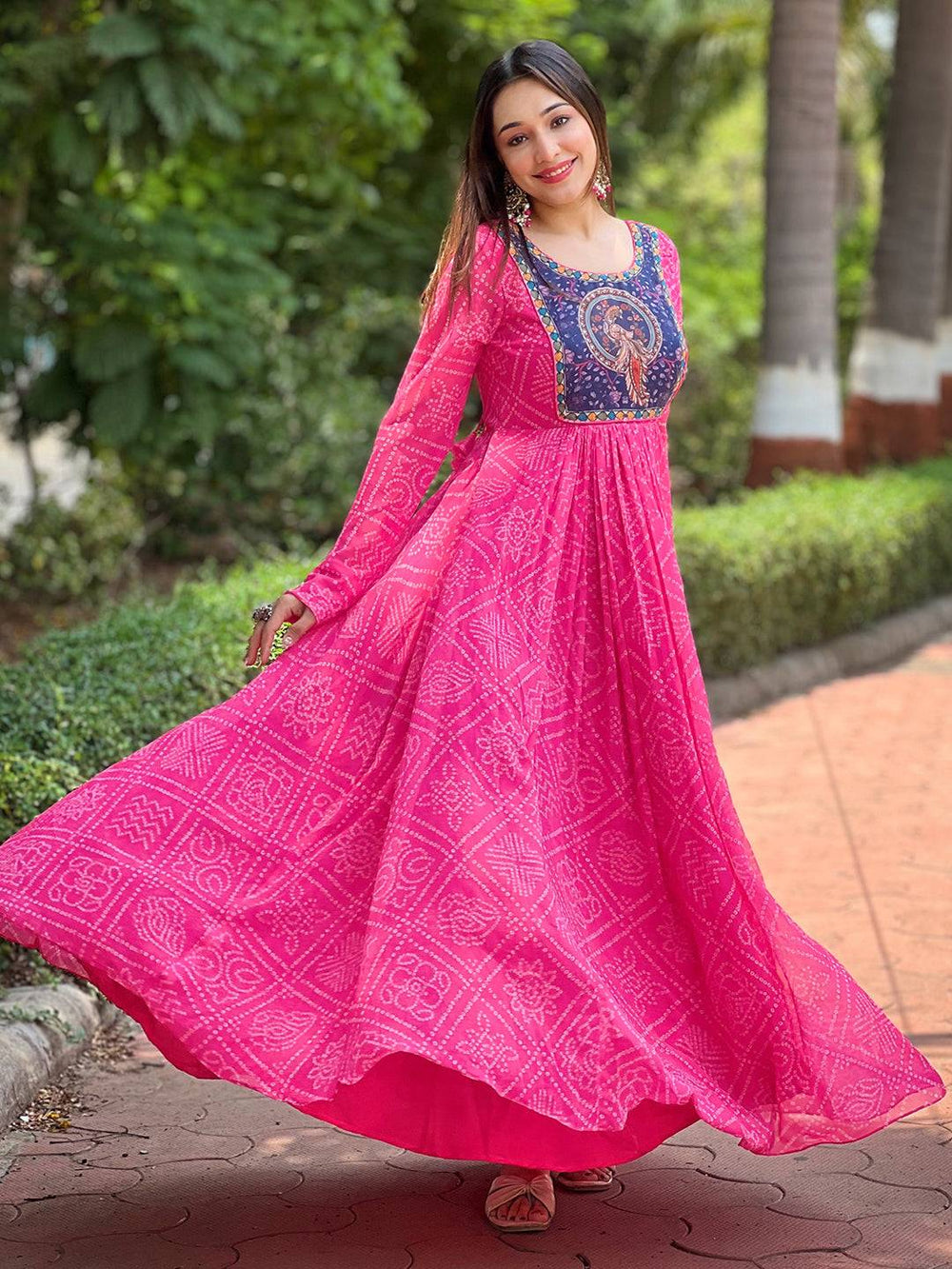 Elegant deep pink Bandhej dress with intricate patterns.