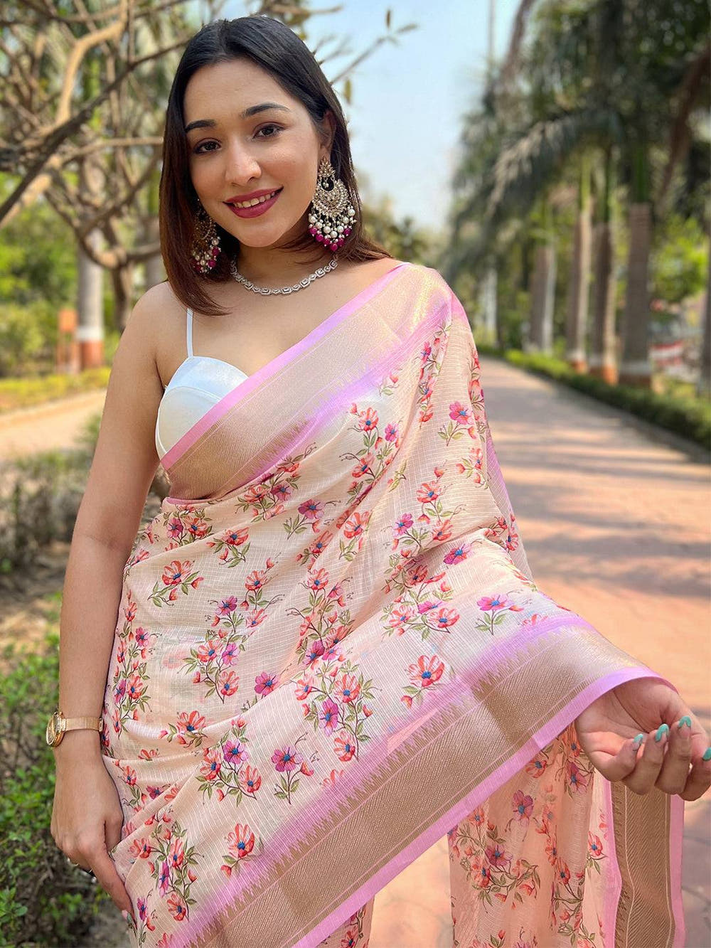 Model smiling in peach Kota saree with digital floral print