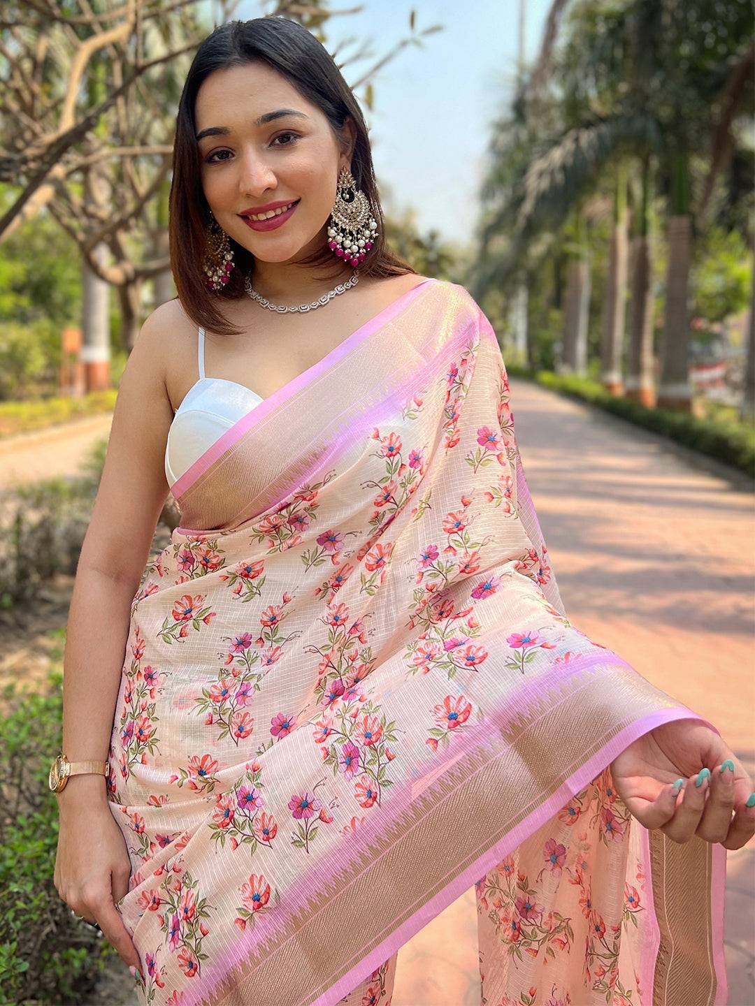 Model smiling in peach Kota saree with digital floral print