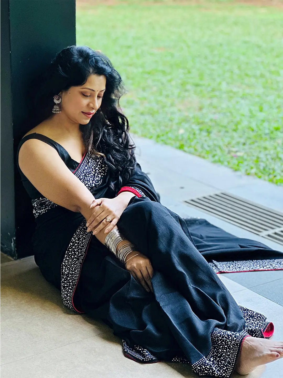 Woman in black saree with silver embellishments