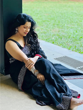Woman in black saree with silver embellishments