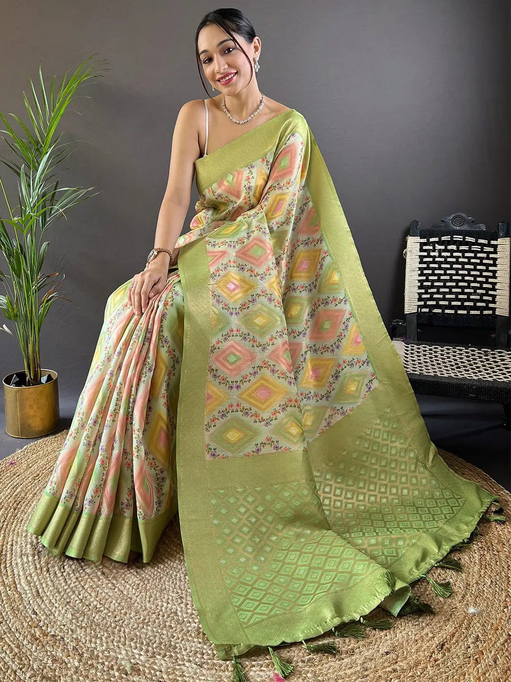 Seated model in Jade Green Flower Vely Print Banarasi Saree.