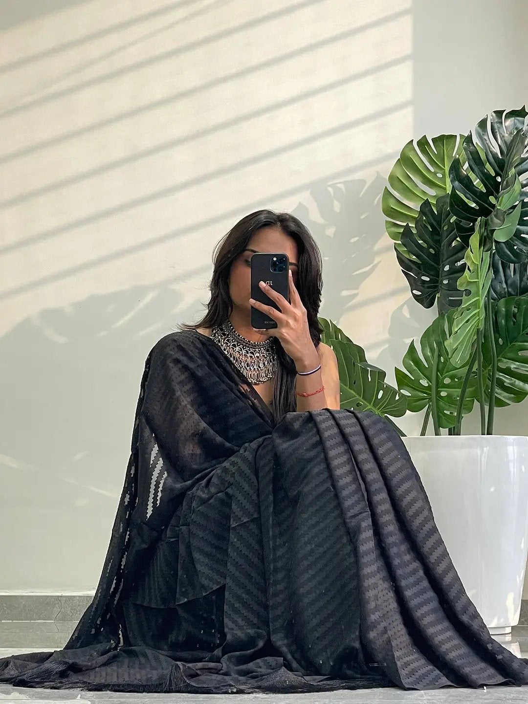 Chic black georgette saree featuring thread weaving