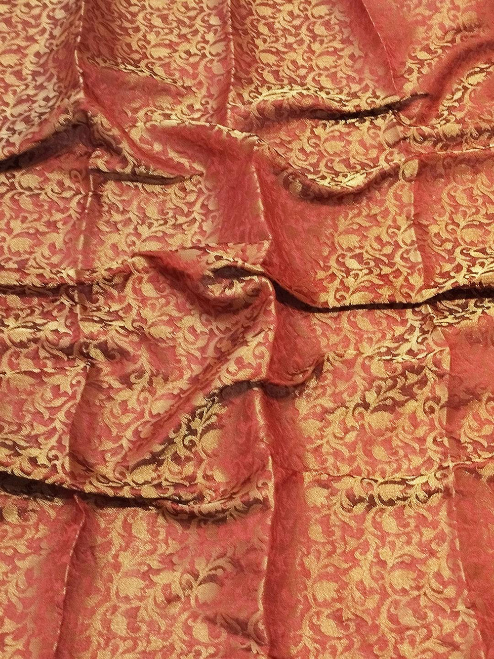 Close-up of brocade zari blouse fabric in red and gold