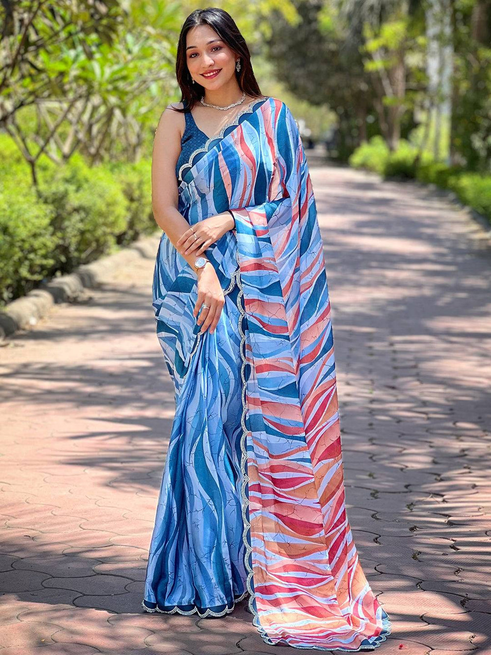 Model showcasing blue batik and polka dots print saree