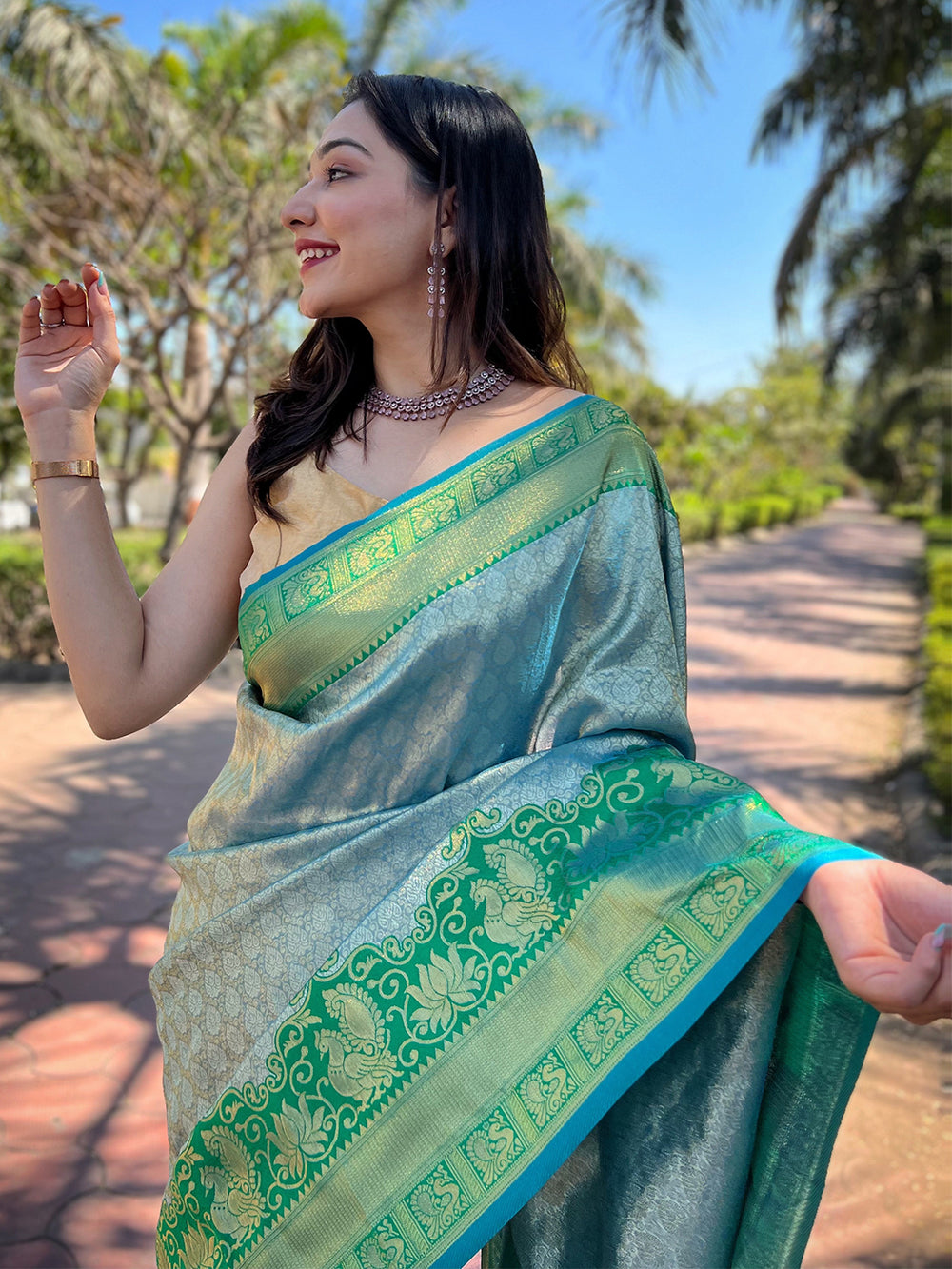 Close-up of green Kanjivaram saree with detailed border