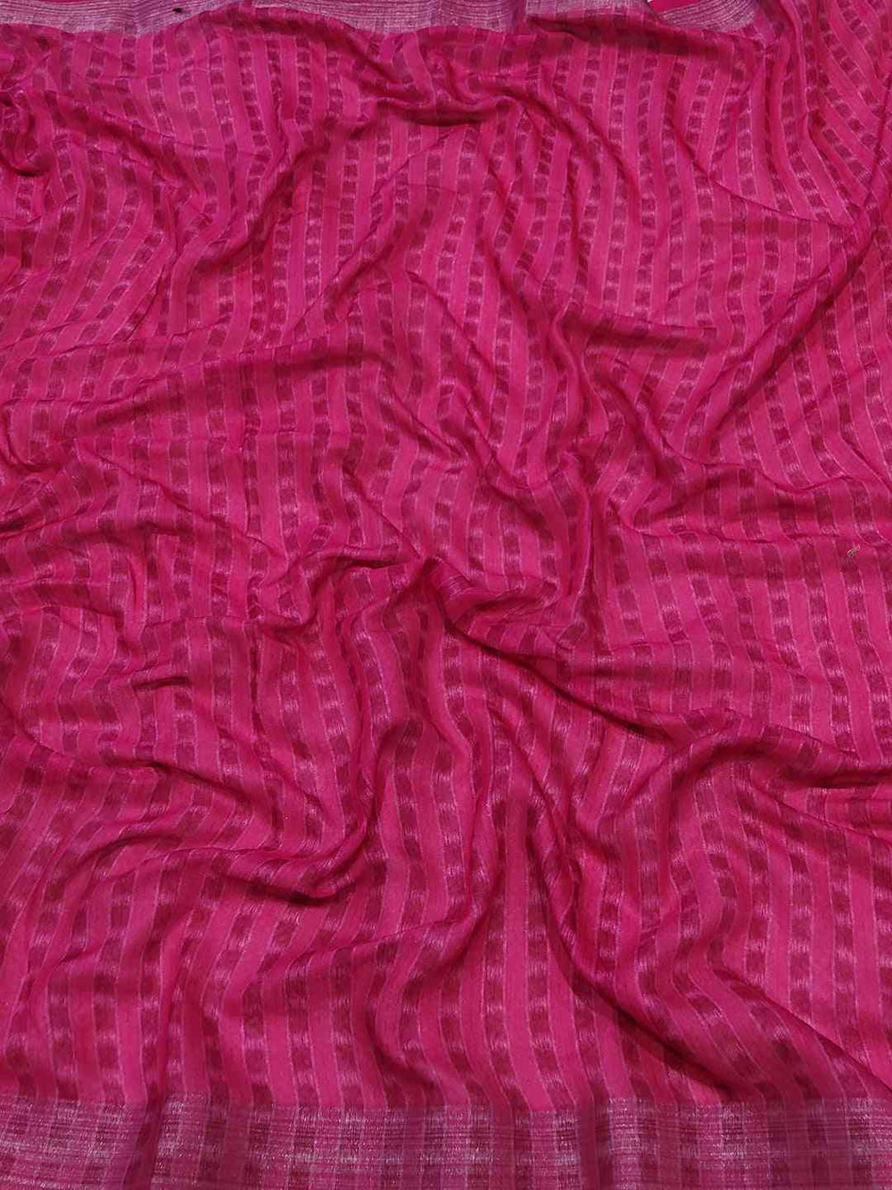 Pink patterned fabric of Ikkat saree, crumpled texture
