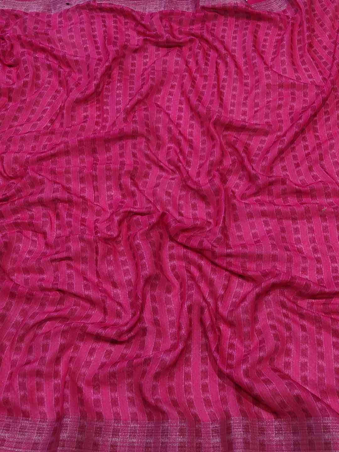 Pink patterned fabric of Ikkat saree, crumpled texture
