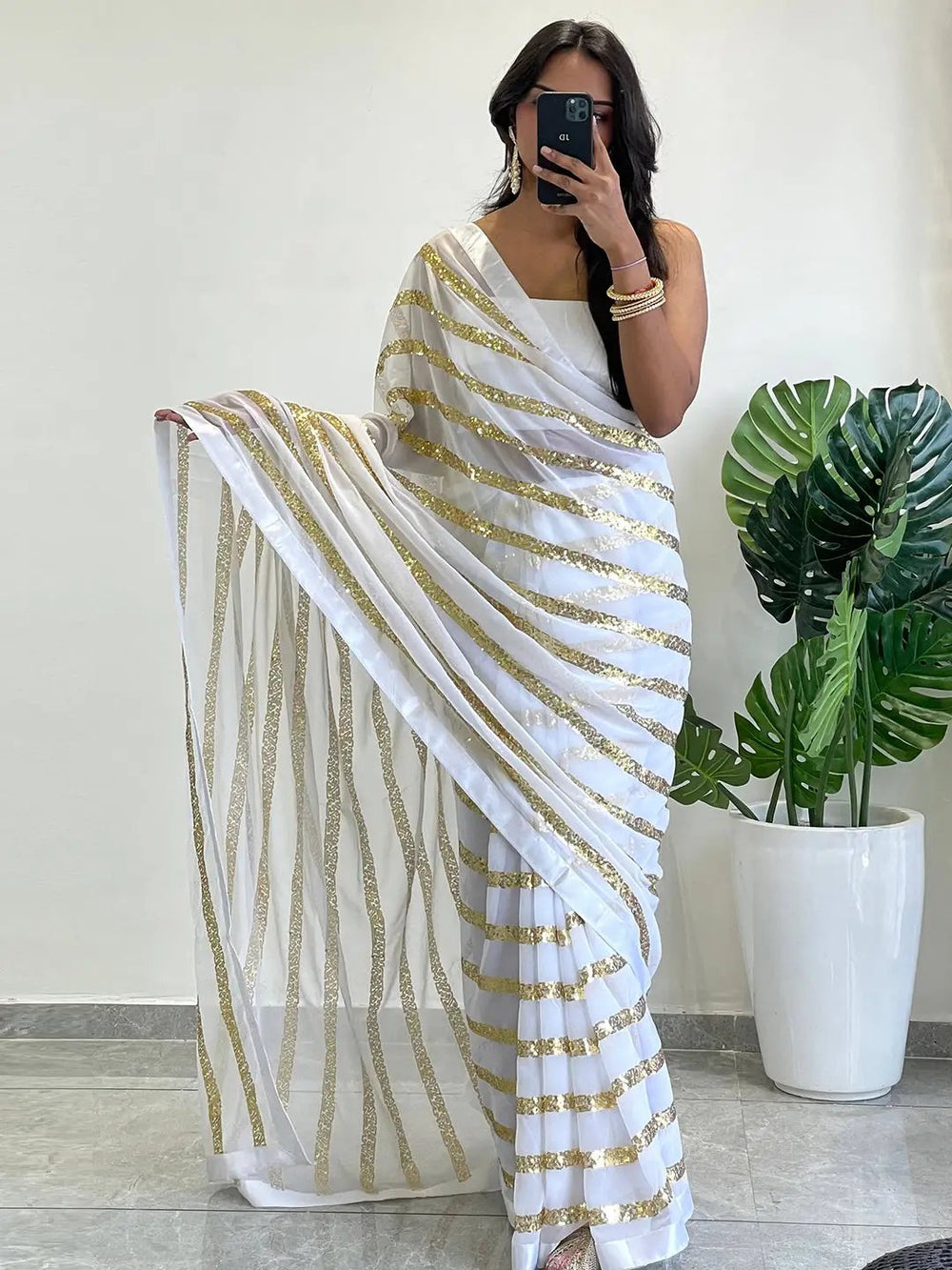 Stylish georgette saree with gold striped sequins design