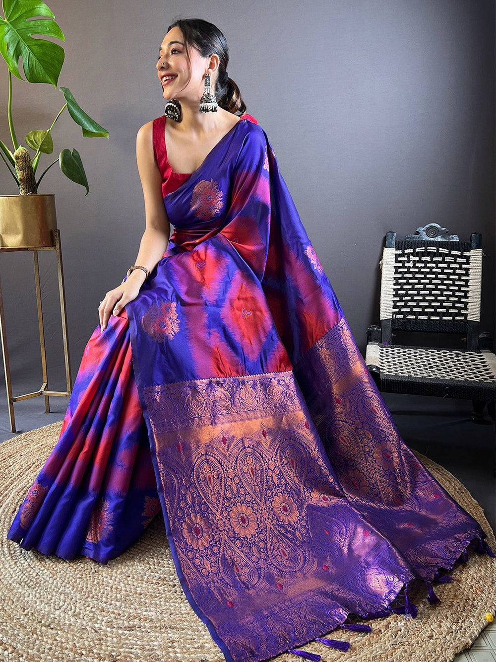 Seated model in Rose Red Tussar Silk Ikkat Weaving Saree