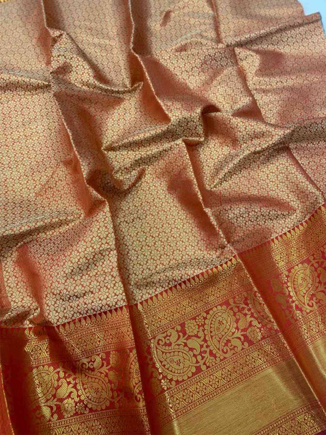 Close-up of gold zari Kanjivaaram pattu silk saree fabric details.