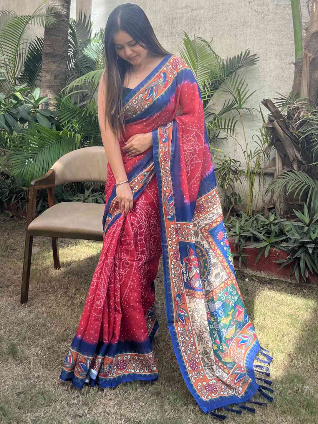 Red linen saree with Bandhej and kalamkari print, adjusting drape