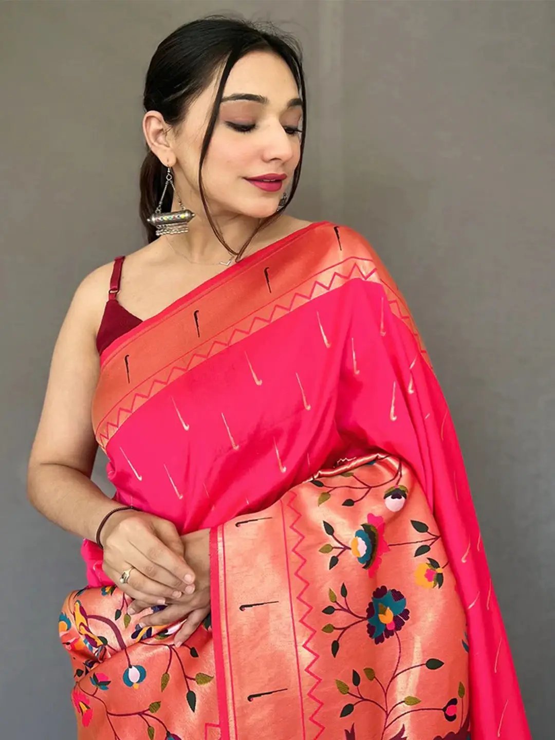 Close-up of pink Paithani saree with detailed zari pattern