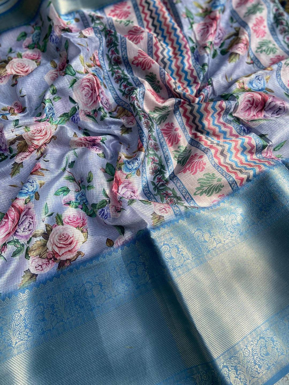 Detailed view of floral and zigzag patterns on lavender saree