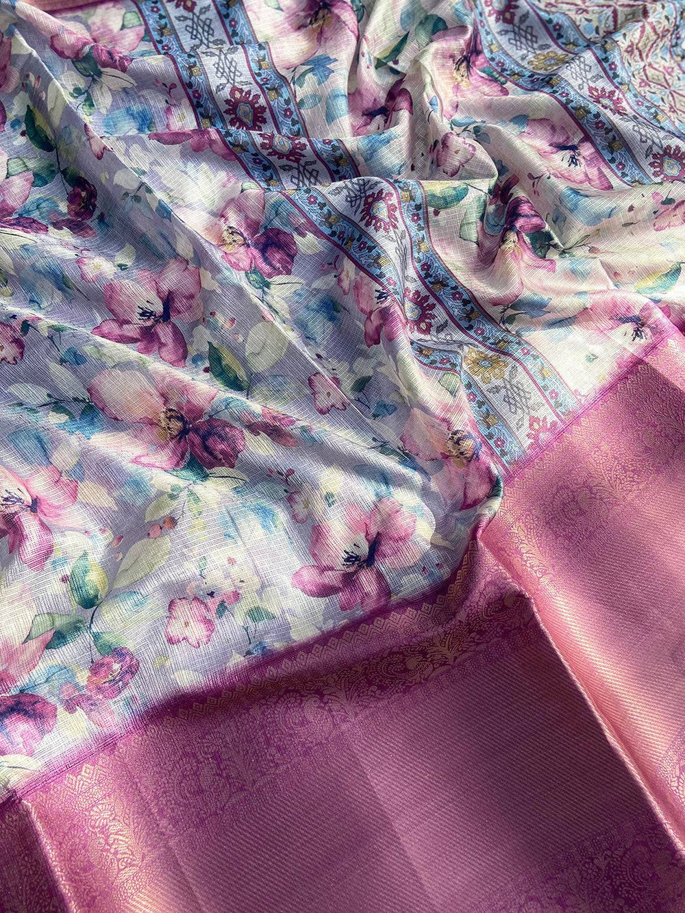 Lavender saree draped to show floral print and zari border