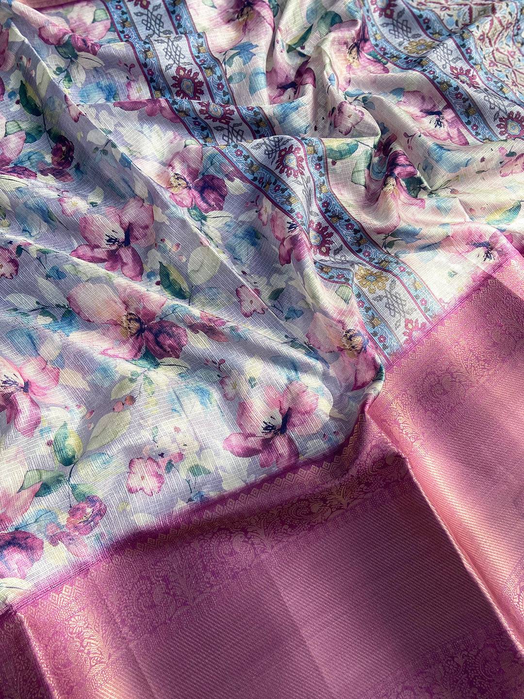 Lavender saree draped to show floral print and zari border