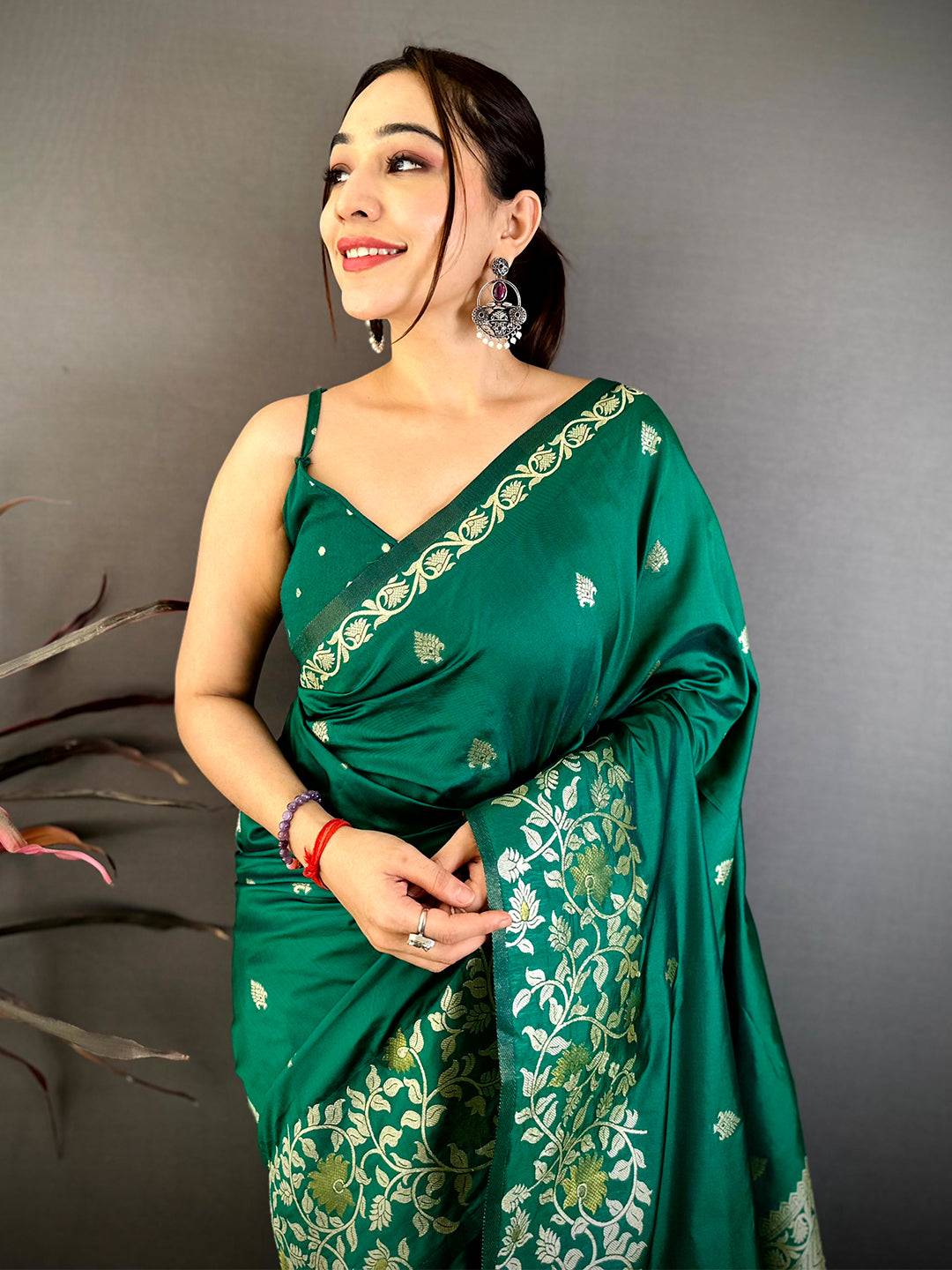 Emerald green silk saree with gold embroidery and intricate border