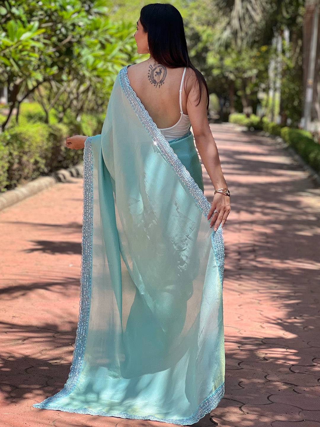 Back view of turquoise pure viscose dyed saree with intricate border