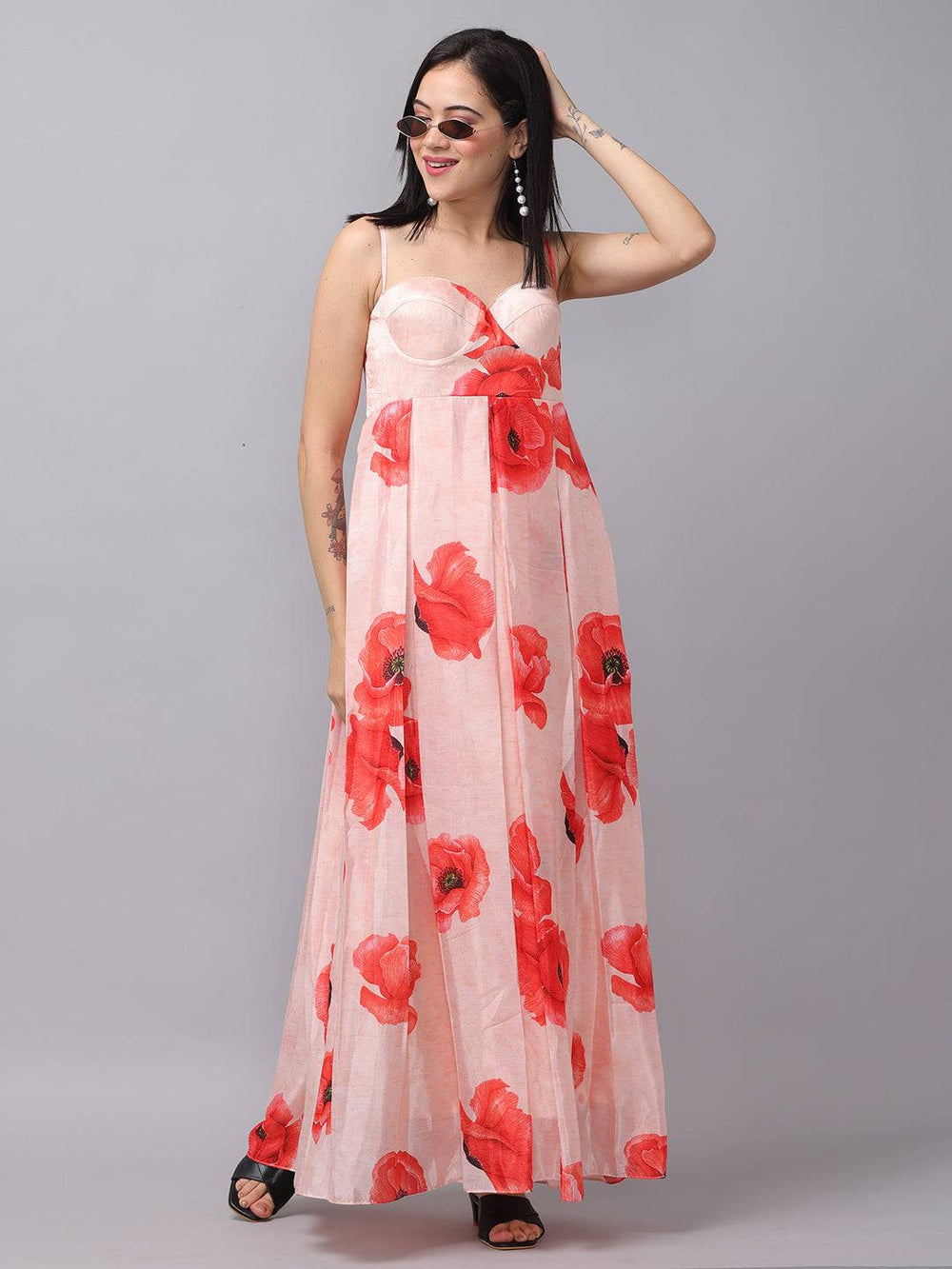 Blush pink dress with red floral print, model posing