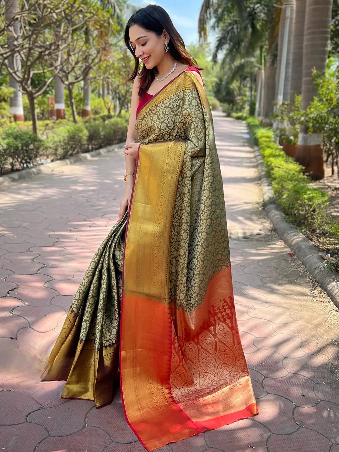 Elegant green gold saree with jacquard design, garden backdrop