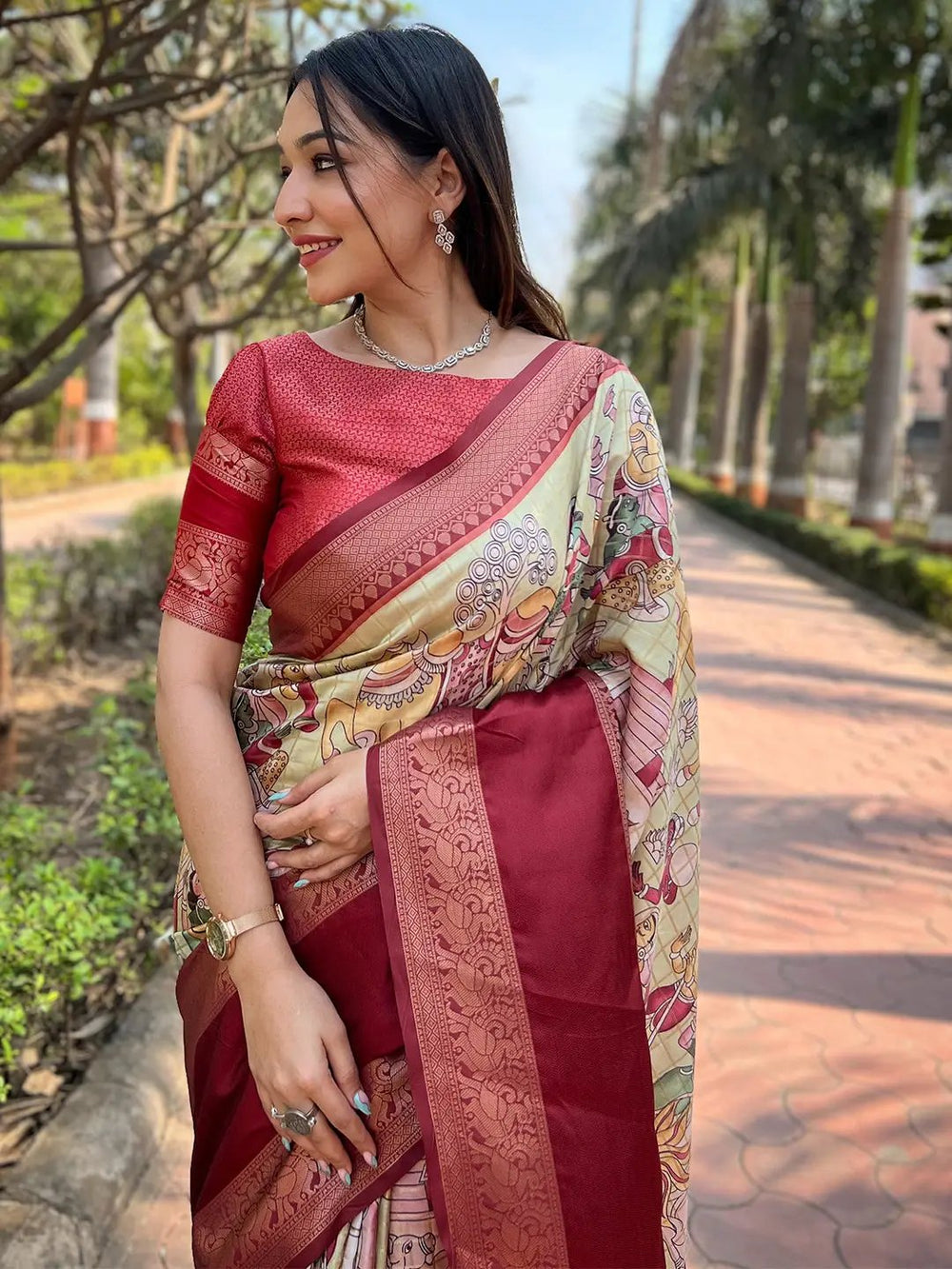 Smiling woman in red Banarasi silk saree with traditional motifs