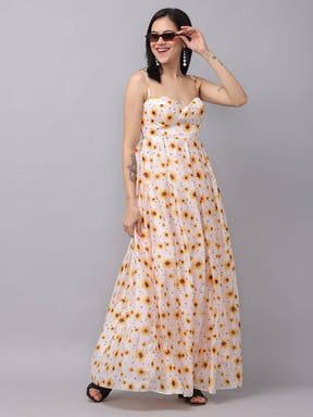 Model posing in white sunflower printed dress, side view.