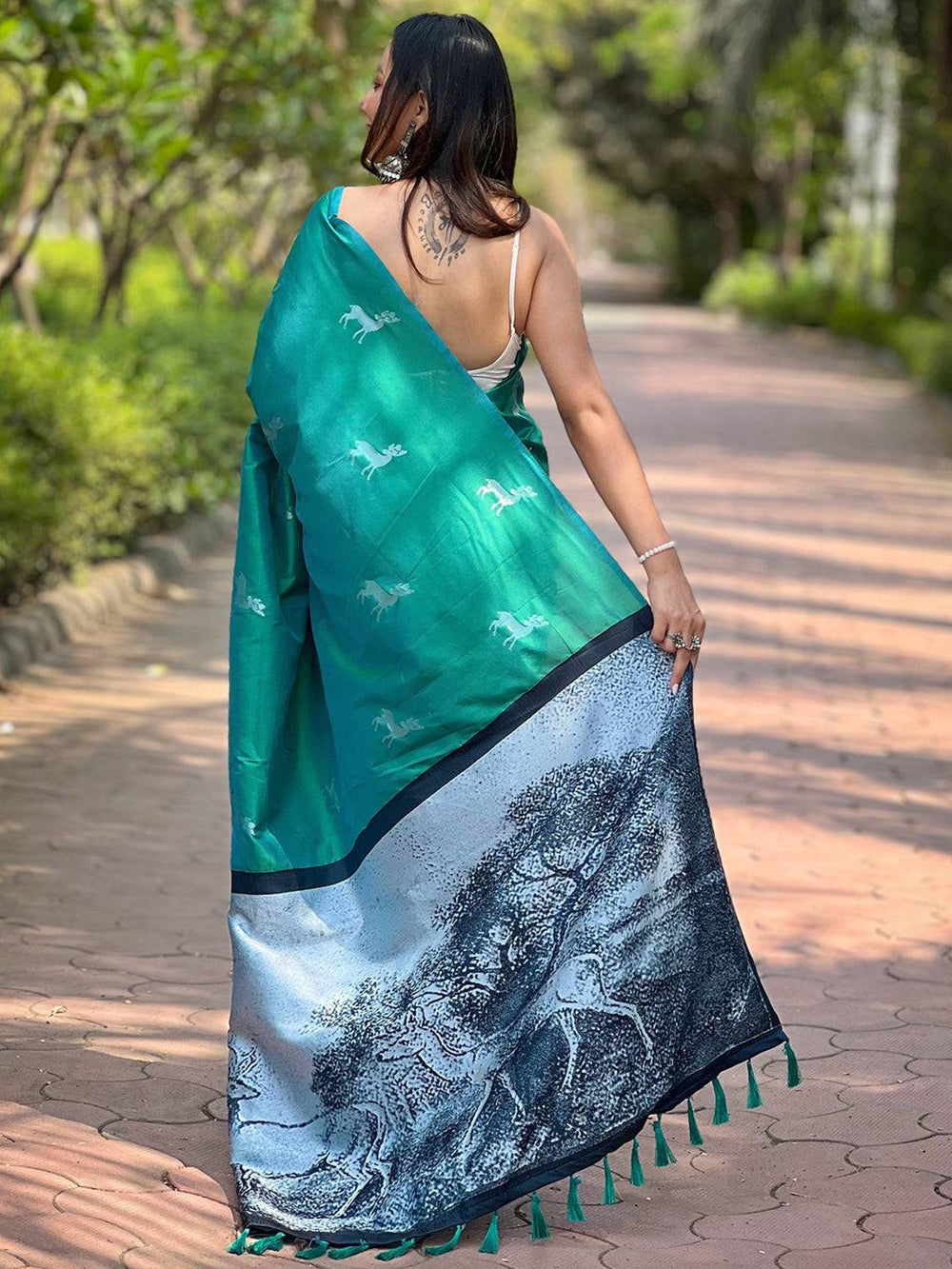 Back view of green silk saree showcasing zari pallu details
