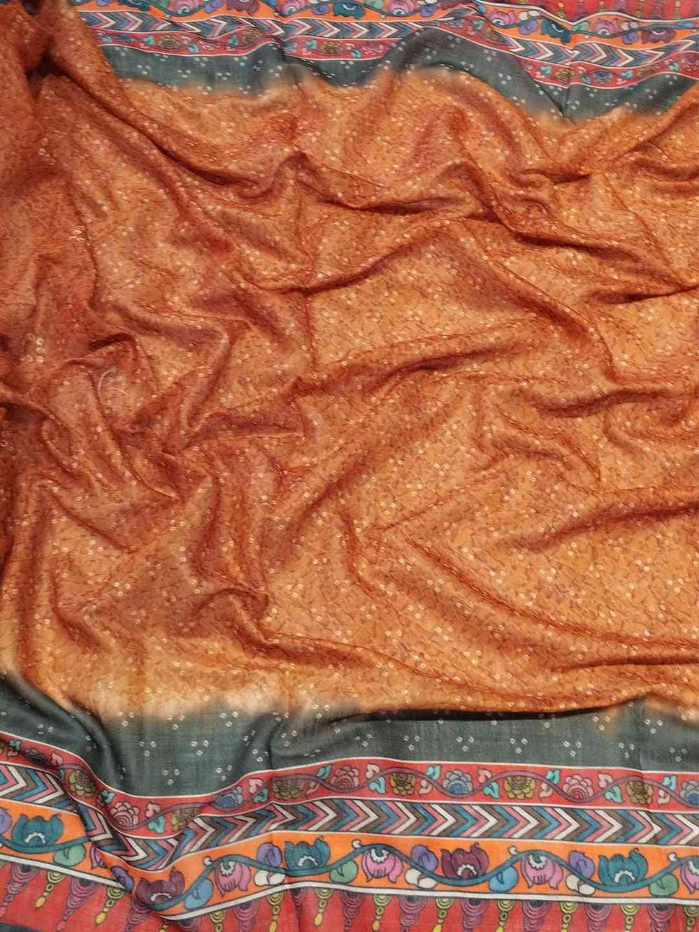 Close-up of orange saree fabric with Bandhej and Kalamkari print