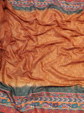 Close-up of orange saree fabric with Bandhej and Kalamkari print