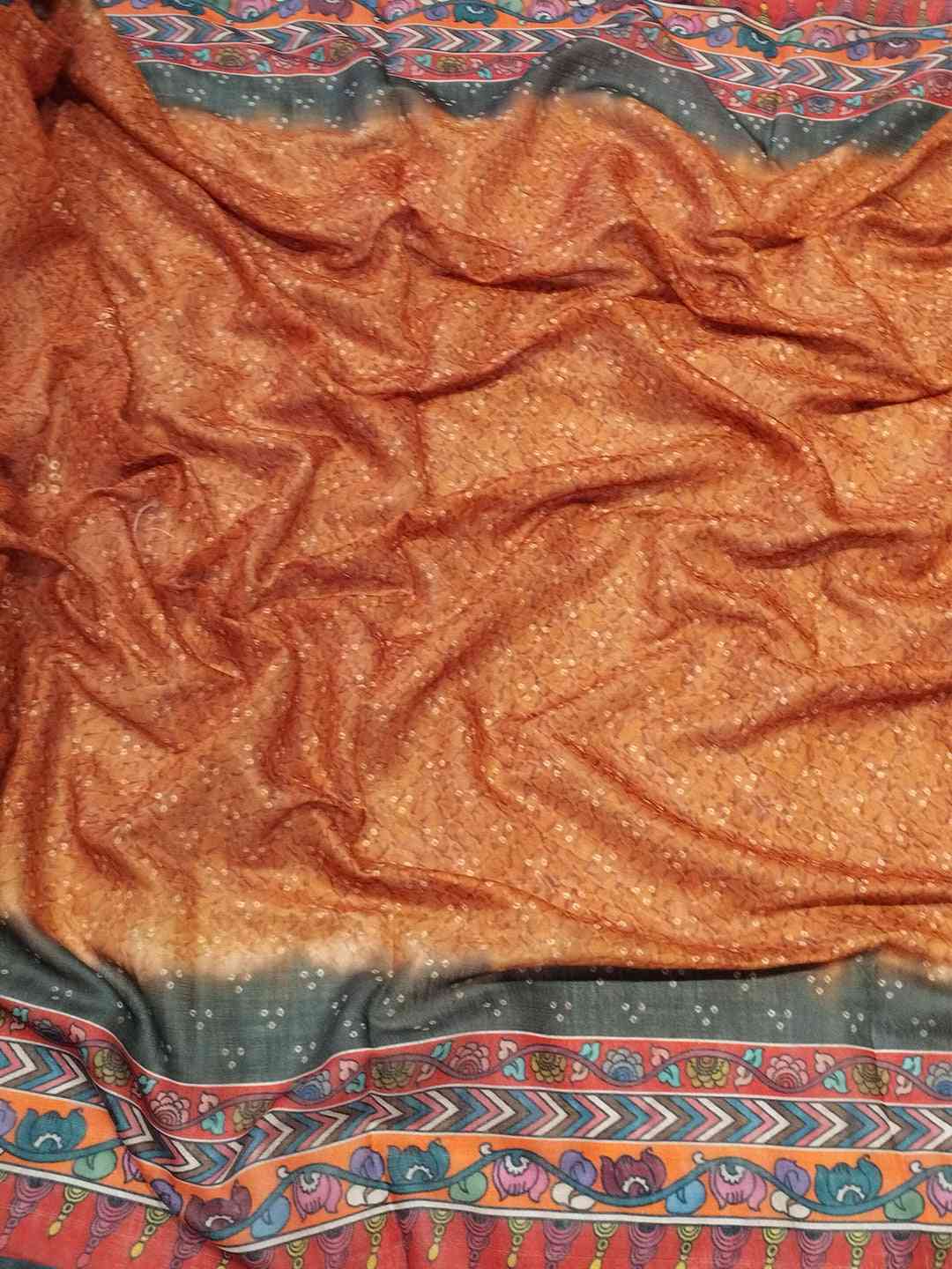 Close-up of orange saree fabric with Bandhej and Kalamkari print